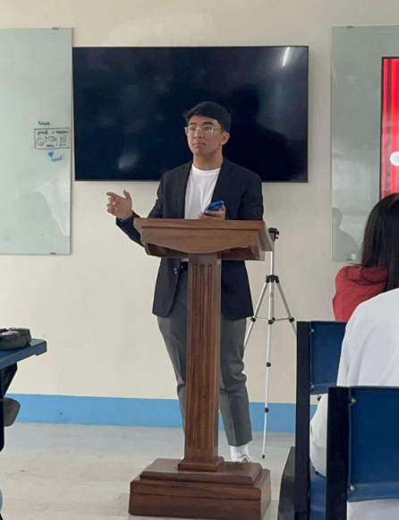 Photo of the AML founder presenting in front of a class